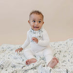 Tee Time + Green Gingham Muslin Quilt | Indulge your little one in the cozy comfort of our Muslin Quilt. Crafted from the same fabric as our beloved muslin swaddles, this four-layer quilt offers warmth and softness for a restful sleep. Our neutral colors