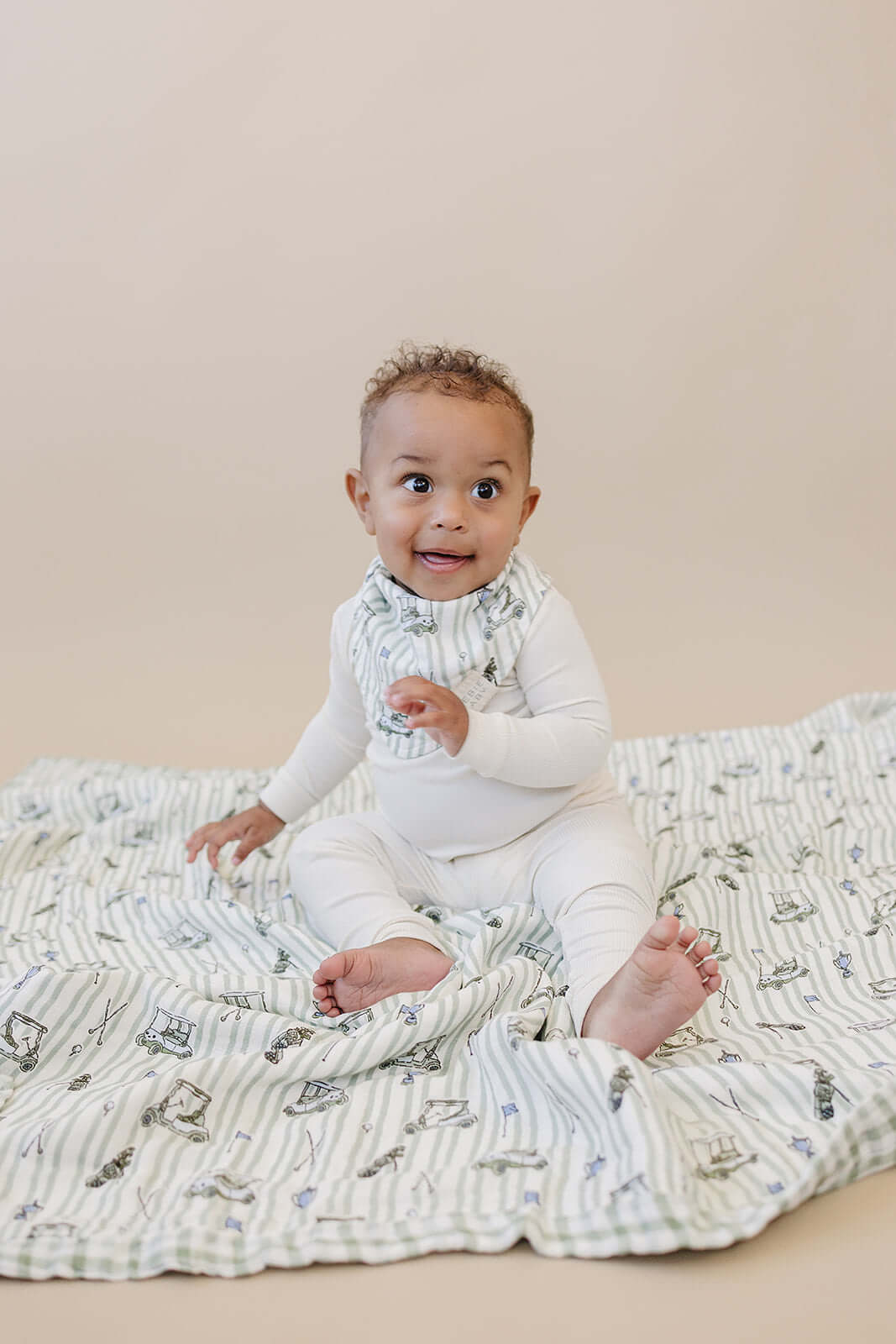 Tee Time + Green Gingham Muslin Quilt | Indulge your little one in the cozy comfort of our Muslin Quilt. Crafted from the same fabric as our beloved muslin swaddles, this four-layer quilt offers warmth and softness for a restful sleep. Our neutral colors