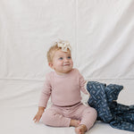 Pink Waffle Set | Milk & Baby | Comfy, cozy, and cute — our Pink Waffle Set is an everyday essential. Made from soft waffle-knit fabric, this matching set includes a long sleeve bodysuit and relaxed-fit pants for a cozy, all-day feel. Snaps at the bottom