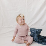 Pink Waffle Set | Milk & Baby | Comfy, cozy, and cute — our Pink Waffle Set is an everyday essential. Made from soft waffle-knit fabric, this matching set includes a long sleeve bodysuit and relaxed-fit pants for a cozy, all-day feel. Snaps at the bottom