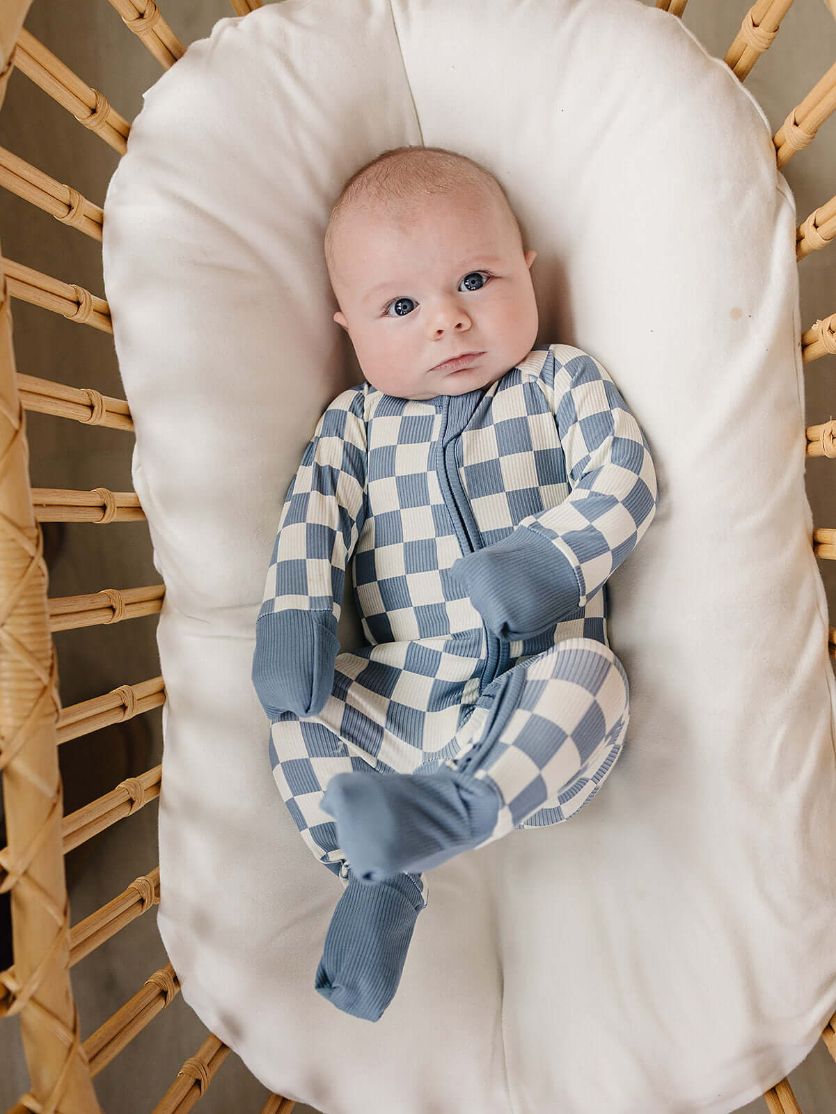 Blue Checkered Bamboo Zipper | The Blue Checkered Bamboo Zipper pajamas are a must-have for your baby's wardrobe. Made from soft bamboo fabric, these gender-neutral footed pajamas feature a convenient double zipper design that allows for easy diaper chang