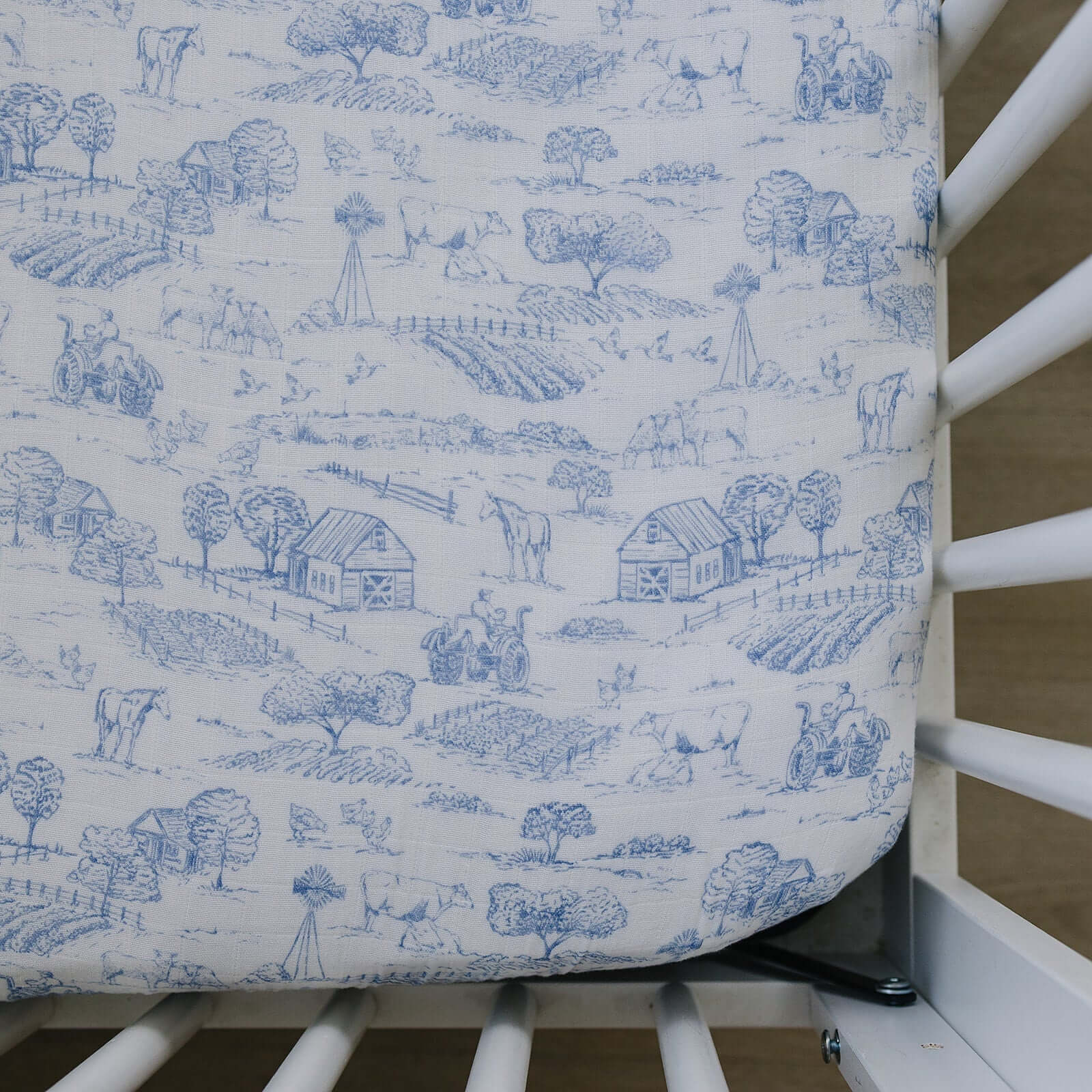 Farm Toile Muslin Crib Sheet | Transform your baby's crib into a cozy haven with our Farm Toile Muslin Crib Sheet. Crafted from our exclusive soft and breathable muslin fabric, this sheet showcases a neutral design that adds a touch of warmth and style to
