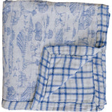 Farm Toile + Blue & Green Plaid Muslin Quilt | Indulge your little one in the cozy comfort of our Muslin Quilt. Crafted from the same fabric as our beloved muslin swaddles, this four-layer quilt offers warmth and softness for a restful sleep. Our neutral