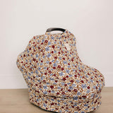 Desert Floral Ribbed Bamboo Multi-Use Cover on a car seat, showcasing its beautiful floral design.