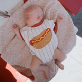 Baby wearing Hot Dogs | Short Sleeve Romper, peacefully sleeping on a cozy blanket.