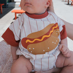 Baby wearing a fun Hot Dogs | Short Sleeve Romper with cute hot dog design, perfect for comfort and play.