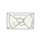 Palm | Bamboo Head Wrap | Milk & Baby | Made from silky-soft bamboo material, this adjustable head wrap features a sweet bow for added style. Perfect for babies and toddlers!One size fits most Print: Palm (a palm tree print on cream background) Material: