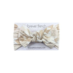 Cottage Quilt | Bamboo Head Wrap | Made from silky-soft bamboo material, this adjustable head wrap features a sweet bow for added style. Perfect for babies and toddlers!One size fits most Print: Cottage Quilt (a neutral quilted pattern) Material: 95% bamb
