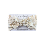 Cottage Quilt | Bamboo Head Wrap | Made from silky-soft bamboo material, this adjustable head wrap features a sweet bow for added style. Perfect for babies and toddlers!One size fits most Print: Cottage Quilt (a neutral quilted pattern) Material: 95% bamb