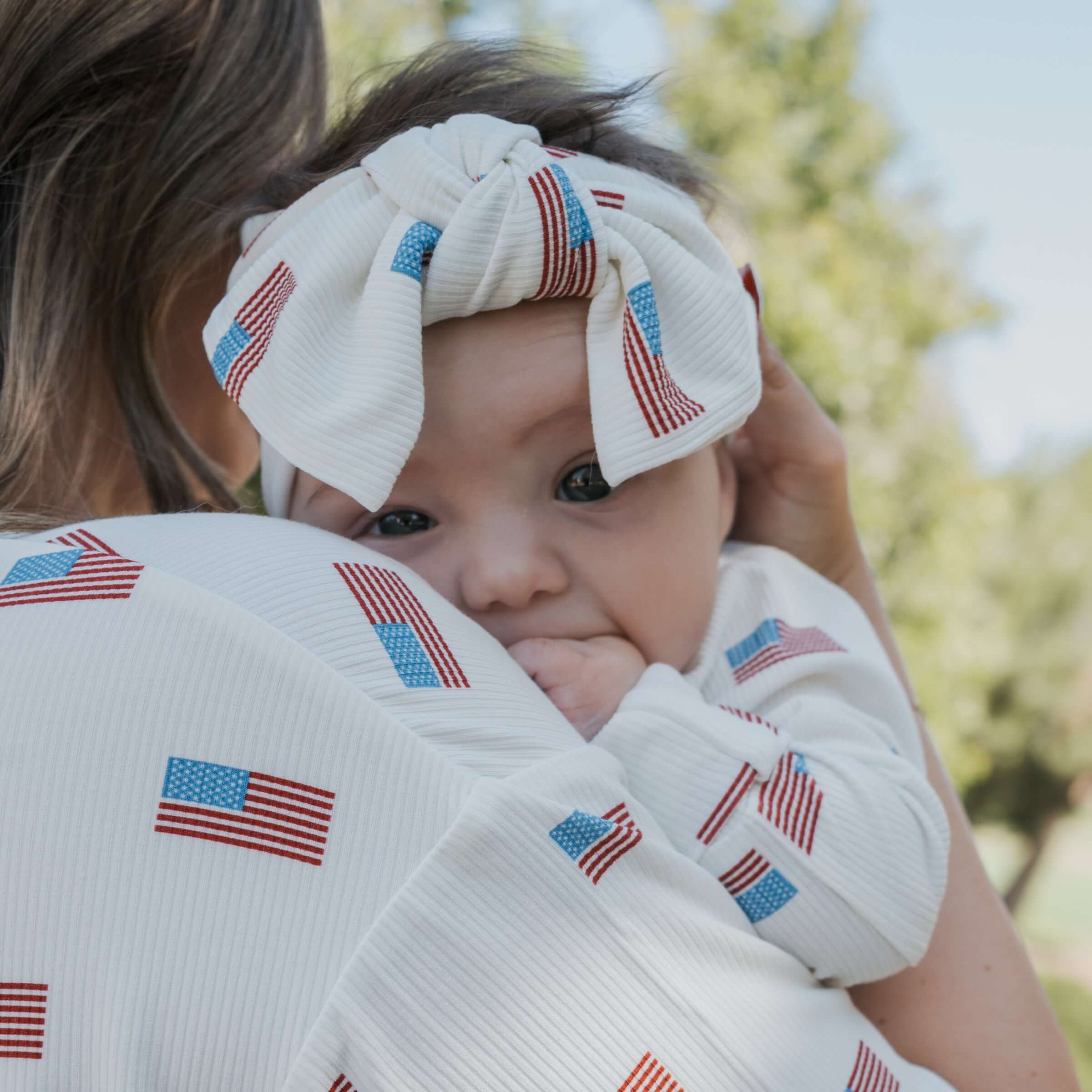 Americana | Ribbed Bamboo Head Wrap on a baby, showcasing the sweet bow and flag print. Perfect for babies and toddlers!