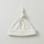Cream Ribbed Bamboo Newborn Knot Hat - Minimal Flat Lay