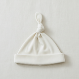 Cream Ribbed Bamboo Newborn Knot Hat - Minimal Flat Lay