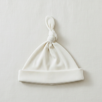 Cream Ribbed Bamboo Newborn Knot Hat - Minimal Flat Lay