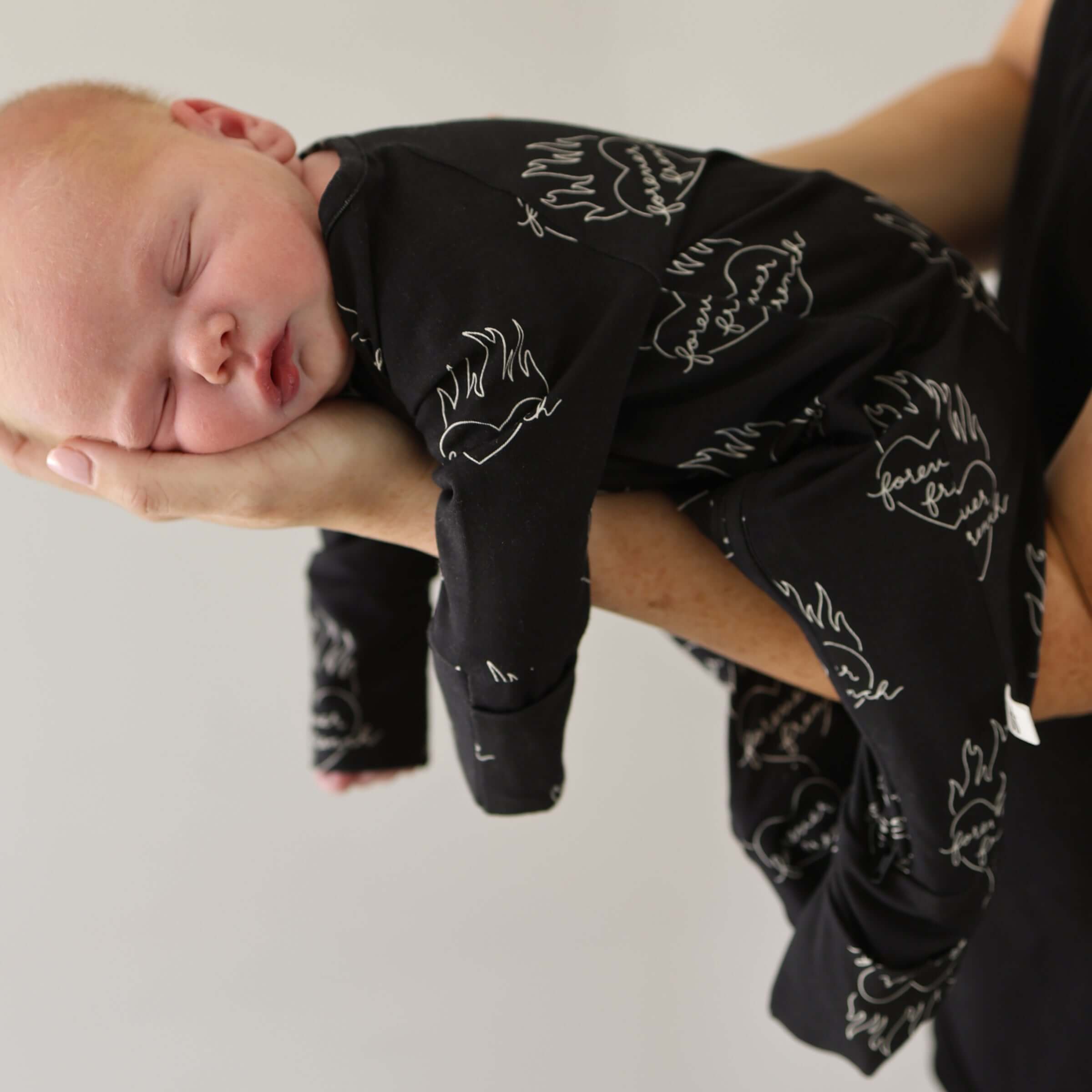 Flaming Hearts | Bamboo Zip Pajamas | Made of the softest premium bamboo. Durable and well designed your little ones can sleep and play in these cozy pajamas. All sizes have rollover cuffs on the hands and cuffs on the feet giving you the option to go foo