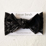 Flaming Hearts | Bamboo Head Wrap | Made from silky-soft bamboo material, this adjustable head wrap features a sweet bow for added style. Perfect for babies and toddlers!One size fits most Print: Flaming Hearts (a flame heart motif featuring "forever fren