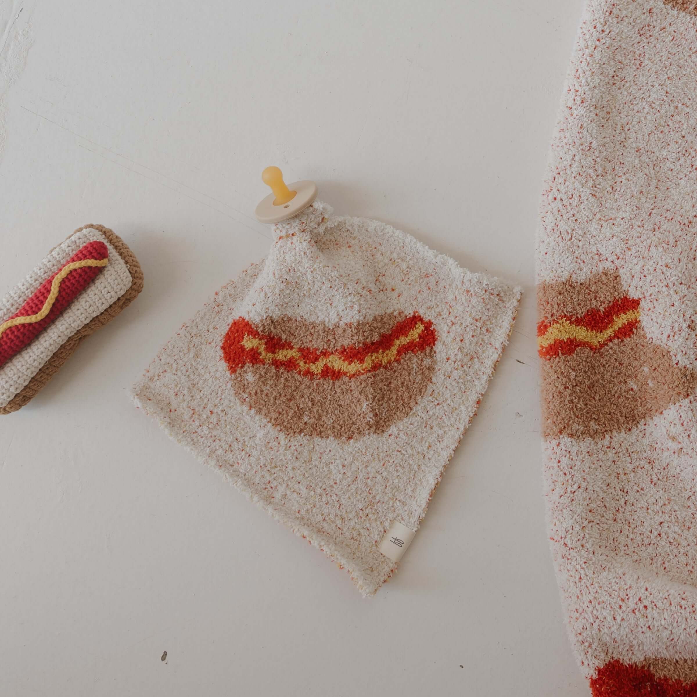 Knit Rattle | Hot Dog with colorful design, perfect for summer fun and cheerful jingles, by Forever French Baby.
