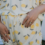 Person wearing a white dress with yellow lemon pattern