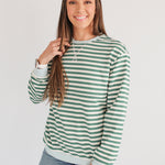 Woman smiling in an oversized fit freestyle stripe breastfeeding sweatshirt, perfect for breastfeeding moms.