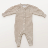 Oatmeal knit button romper with more space and a subtle background