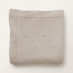 Oatmeal pointelle blanket with more space and a subtle background