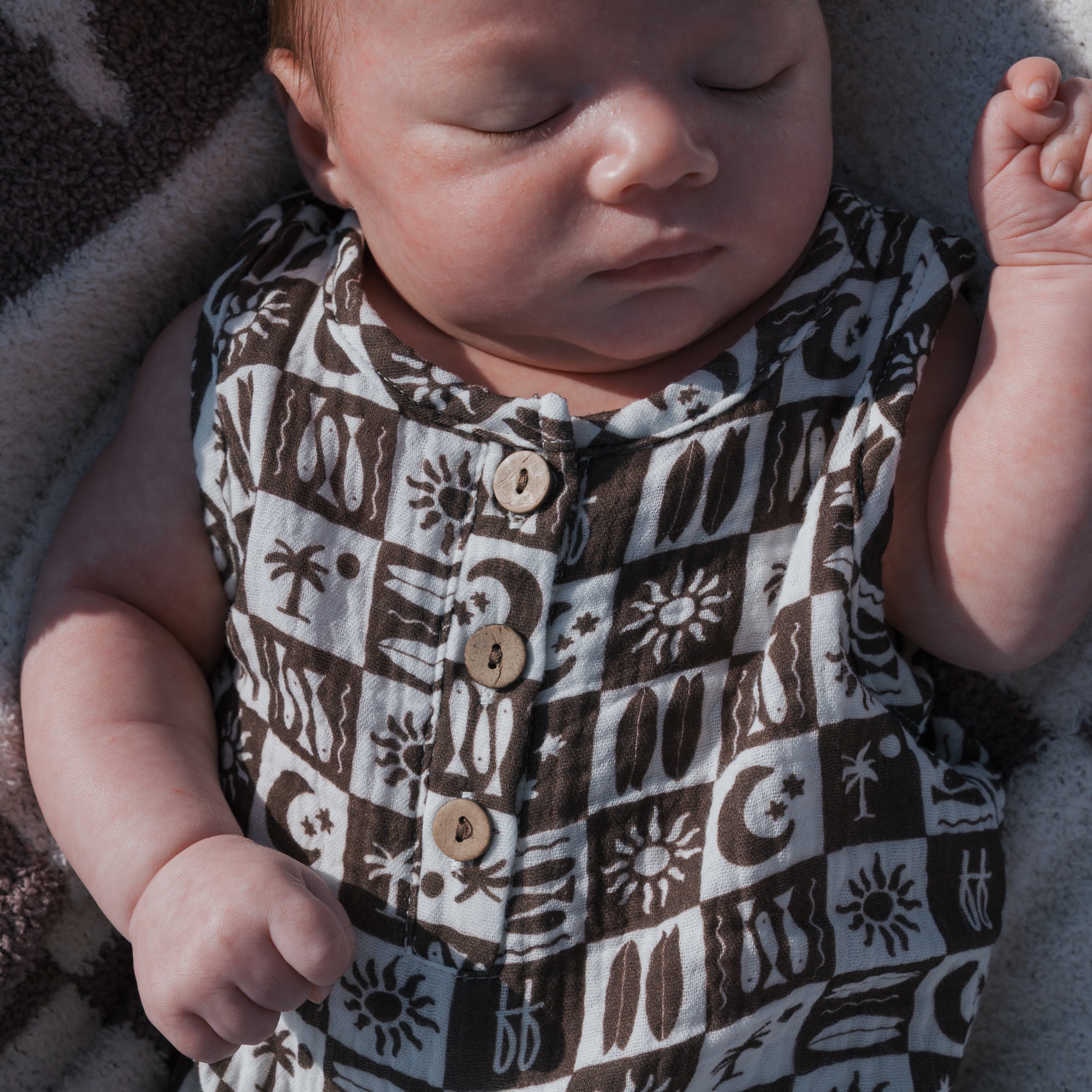 Baby wearing Summer Check | Muslin Tank Romper, featuring a button front and checker print design.