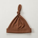 Rust Bamboo Newborn Knot Hat - Minimal Flat Lay