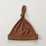 Rust Bamboo Newborn Knot Hat - Minimal Flat Lay