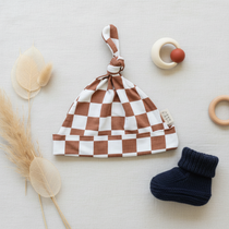 Rust Checkered Bamboo Newborn Knot Hat - Flat Lay