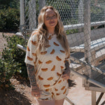 Hot Dogs | Women's Bamboo Short Set model smiling outdoors, wearing a fun oversized t-shirt and drawstring shorts.
