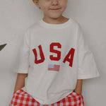 Child wearing USA cotton tee, perfect for festive occasions, representing USA Mommy & Me style.