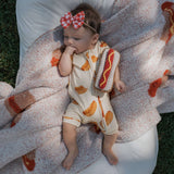 Baby enjoying comfort in Hot Dogs | Shortie Bamboo Zip pajamas, perfect for sleeping and playing | milk & baby.