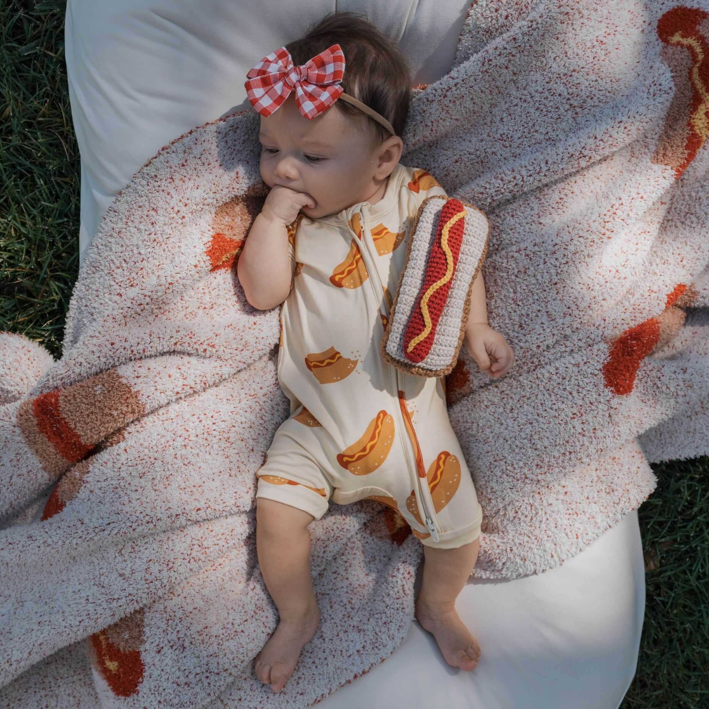 Baby enjoying comfort in Hot Dogs | Shortie Bamboo Zip pajamas, perfect for sleeping and playing | milk & baby.