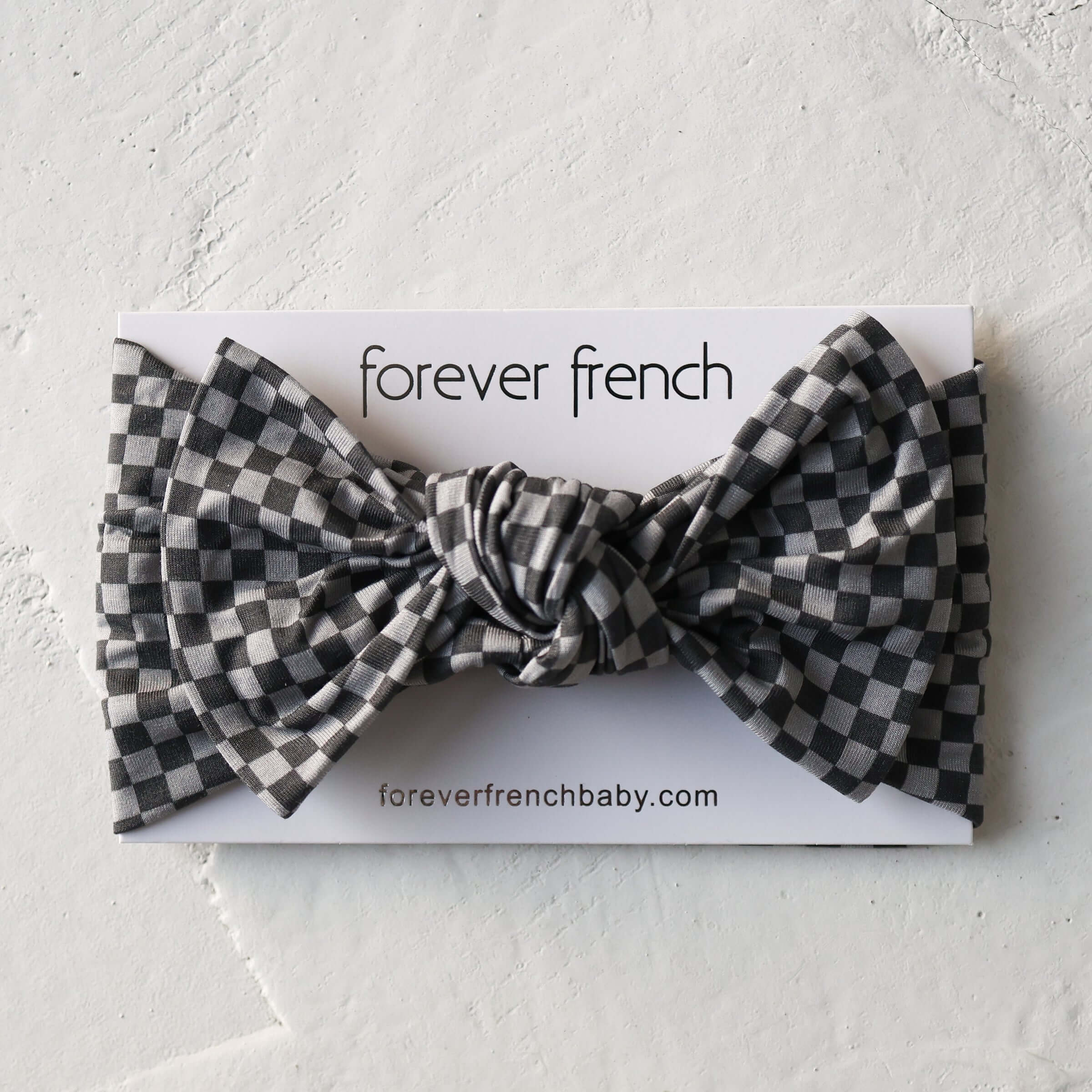Street Micro Check | Bamboo Head Wrap | Made from silky-soft bamboo material, this adjustable head wrap features a sweet bow for added style. Perfect for babies and toddlers!One size fits most Print: Street Micro Check (a grey and black micro checkerboard