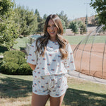 Americana | Ribbed Women's Bamboo Short Set on a smiling model in a sunny park setting with a baseball field.