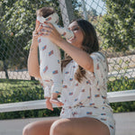 Mom enjoying quality time with baby in Americana | Ribbed Bamboo Zip Pajamas, featuring a playful flag design.