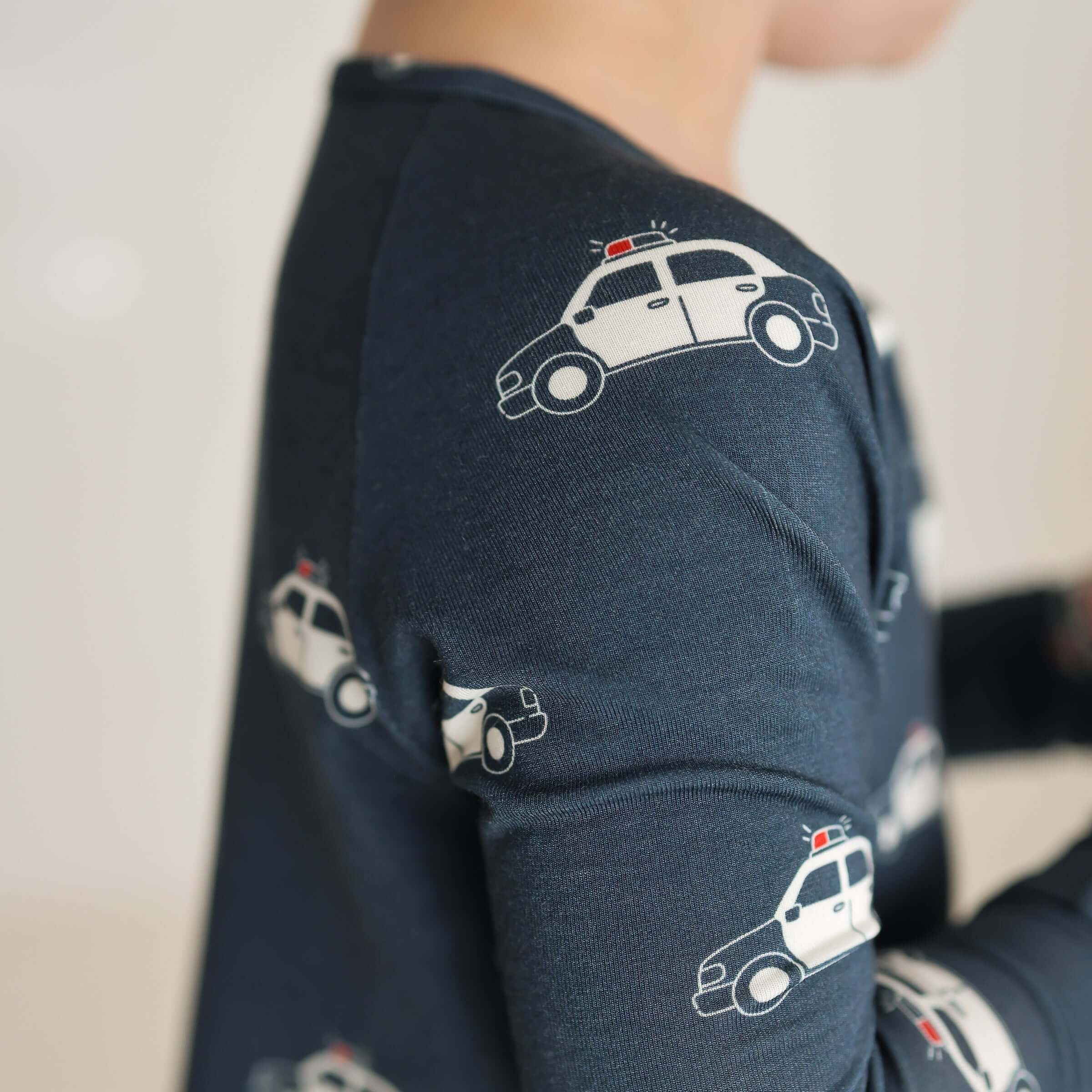 Police Cruiser | Bamboo Zip Pajamas | Made of the softest premium bamboo. Durable and well designed your little ones can sleep and play in these cozy pajamas. All sizes have rollover cuffs on the hands and on the feet giving you the option to go footless