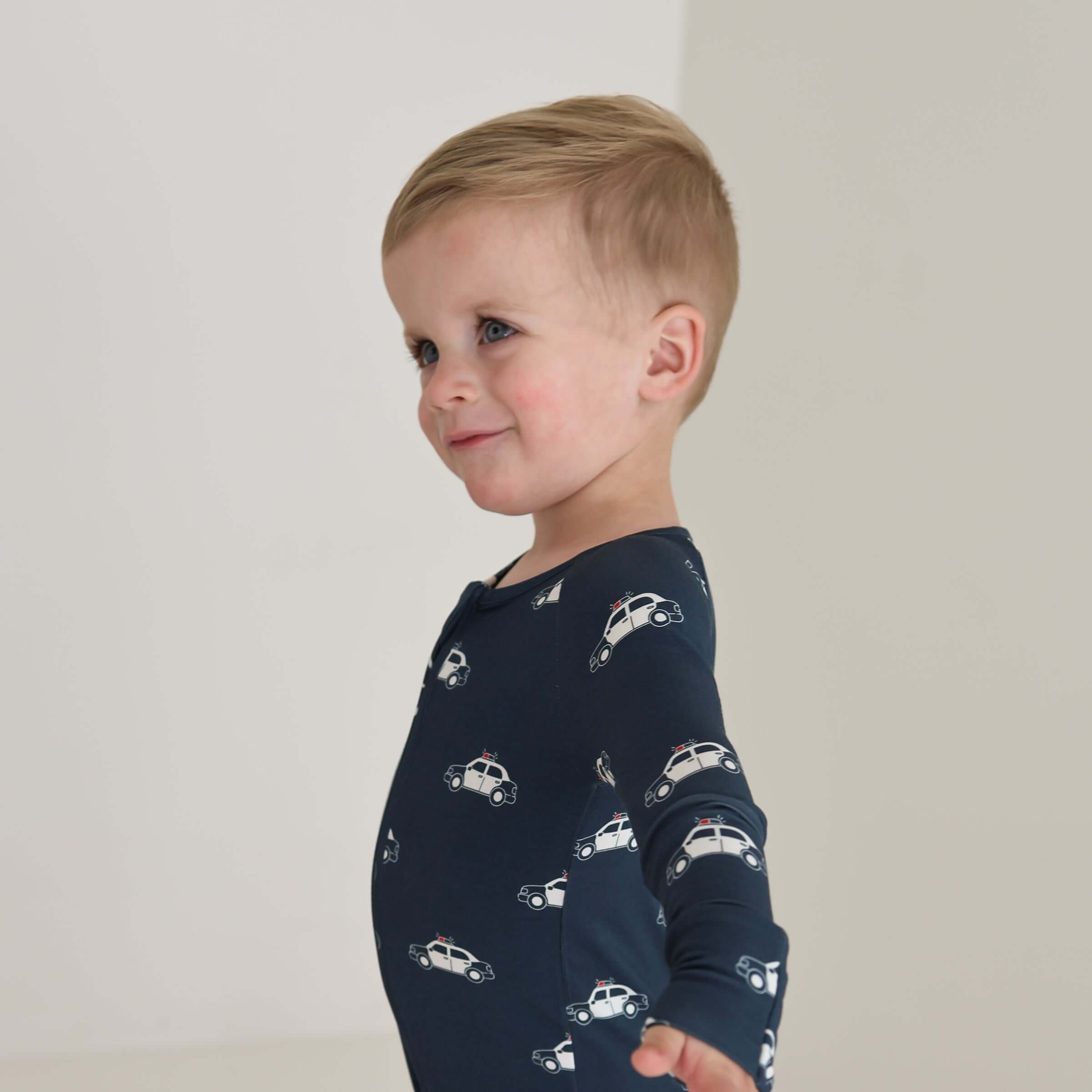 Police Cruiser | Bamboo Zip Pajamas | Made of the softest premium bamboo. Durable and well designed your little ones can sleep and play in these cozy pajamas. All sizes have rollover cuffs on the hands and on the feet giving you the option to go footless