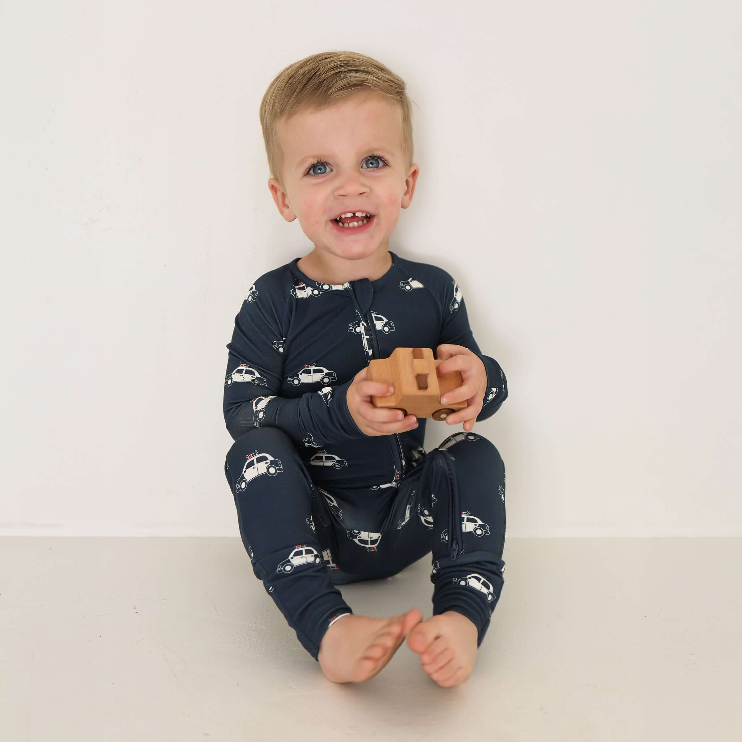 Police Cruiser | Bamboo Zip Pajamas | Made of the softest premium bamboo. Durable and well designed your little ones can sleep and play in these cozy pajamas. All sizes have rollover cuffs on the hands and on the feet giving you the option to go footless
